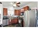 Modern kitchen with stainless steel appliances, wood cabinets, and a pass-through to the living area for easy entertaining at 2253 Bridlewood Dr, Franklin, IN 46131