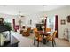 Open-concept living room with a dining area featuring a round table and comfortable seating, exuding an inviting atmosphere at 2253 Bridlewood Dr, Franklin, IN 46131
