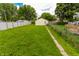 Large backyard featuring green grass and a shed in the distance at 2350 E Legrande Ave, Indianapolis, IN 46203
