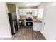 Bright kitchen featuring stainless steel appliances and new wood laminate floors at 2350 E Legrande Ave, Indianapolis, IN 46203