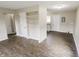 Open-concept living room featuring built-in shelving and new laminate flooring at 2350 E Legrande Ave, Indianapolis, IN 46203