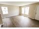 Sunlit living room with new floors, white trim, and two large windows at 2350 E Legrande Ave, Indianapolis, IN 46203