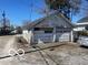 Two-car garage showing peeling white paint on doors and weathered exterior siding at 2519 N A St, Elwood, IN 46036
