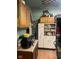 A cramped kitchen with outdated appliances and cluttered counter at 2519 N A St, Elwood, IN 46036