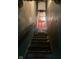 An indoor stairwell leads up to a room with a orange door at 2519 N A St, Elwood, IN 46036