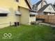 Backyard featuring chainlink and wood fence with green lawn area at 2830 Guilford Ave, Indianapolis, IN 46205