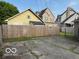 The backyard features a concrete pad and a wooden fence with other houses visible at 2830 Guilford Ave, Indianapolis, IN 46205