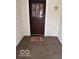 Inviting front entrance featuring a wooden door and a 'Home Sweet Home' welcome mat at 2830 Guilford Ave, Indianapolis, IN 46205