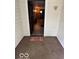Front entrance featuring a wooden door and a 'Home Sweet Home' welcome mat at 2830 Guilford Ave, Indianapolis, IN 46205