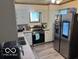 Kitchen with white cabinets, stainless steel appliances, and light countertops at 2830 Guilford Ave, Indianapolis, IN 46205