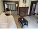 Open-concept living room with a cozy seating area, fireplace, and durable flooring at 2830 Guilford Ave, Indianapolis, IN 46205