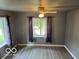 Cozy living room featuring light gray walls, wood-look floors, and a ceiling fan at 2830 Guilford Ave, Indianapolis, IN 46205