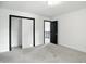 Bright bedroom featuring carpet, closet space, and neutral paint, creating a warm and inviting space for rest and relaxation at 3210 Hovey St, Indianapolis, IN 46218