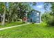 Charming two-story home with blue siding, green lawn, and sidewalk entrance at 3210 Hovey St, Indianapolis, IN 46218