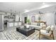 Open-concept living room flows seamlessly into the kitchen, featuring modern furnishings and a bright, airy atmosphere at 3210 Hovey St, Indianapolis, IN 46218
