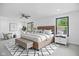 Bright main bedroom with modern furnishings, a ceiling fan, and large windows for natural light at 3210 Hovey St, Indianapolis, IN 46218