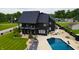 Aerial view of a modern home with a pool, patio, and beautifully landscaped yard at 3306 Mullinix Rd, Greenwood, IN 46143