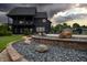Landscaped backyard with decorative rocks, a retaining wall, and a partial view of the house at 3306 Mullinix Rd, Greenwood, IN 46143