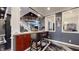 Bar area with seating, dark cabinets, and views of the staircase and living room at 3306 Mullinix Rd, Greenwood, IN 46143