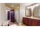 Bathroom featuring double vanity sinks, tiled floors, and a separate shower behind a curtain at 3306 Mullinix Rd, Greenwood, IN 46143