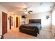 Spacious bedroom with a ceiling fan and large bed; doors lead to the ensuite bathroom at 3306 Mullinix Rd, Greenwood, IN 46143