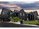 Elegant home with a black exterior, arched windows, a charming front yard, and a secure fence at 3306 Mullinix Rd, Greenwood, IN 46143