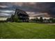 Stunning two-story home with a striking black exterior, lush green lawn, and inviting curb appeal at 3306 Mullinix Rd, Greenwood, IN 46143