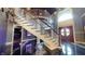 Grand foyer features a striking staircase, high ceilings, and unique flooring, creating an impressive entryway at 3306 Mullinix Rd, Greenwood, IN 46143
