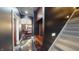 Hallway with dark walls, shiny floors, a staircase, and a custom built-in bench with coat hooks at 3306 Mullinix Rd, Greenwood, IN 46143