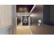 Long hallway with dark paint, white trim, and unique art pieces hung on the walls at 3306 Mullinix Rd, Greenwood, IN 46143