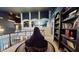 Second story hallway with dark walls, view of sitting area with bear statue, and a full bookshelf at 3306 Mullinix Rd, Greenwood, IN 46143