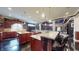 Open kitchen featuring two islands with granite counters, pendant lights, and dark cabinetry at 3306 Mullinix Rd, Greenwood, IN 46143