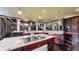 A spacious kitchen features an island with granite counters, cooktop, and stainless steel appliances at 3306 Mullinix Rd, Greenwood, IN 46143