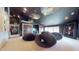 A dark media room with multiple black bean bag chairs, a TV, and unique ceiling lighting at 3306 Mullinix Rd, Greenwood, IN 46143