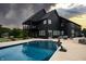 Beautiful backyard with a sparkling in-ground pool and patio seating area for entertaining at 3306 Mullinix Rd, Greenwood, IN 46143