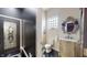 Charming powder room with a unique mirror and glass block window at 3306 Mullinix Rd, Greenwood, IN 46143