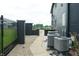 Well-maintained side yard with a fence, gravel ground cover, and modern air conditioning units at 3306 Mullinix Rd, Greenwood, IN 46143