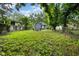 Fenced back yard with a fire pit and mature trees at 3562 E Morris St, Indianapolis, IN 46203