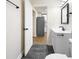 Bathroom with a white vanity, black hardware, and doorway view into kitchen at 3562 E Morris St, Indianapolis, IN 46203