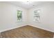 Empty room with vinyl flooring and two windows at 3562 E Morris St, Indianapolis, IN 46203