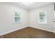 Bright bedroom with hardwood floors, two windows, and ample space at 3562 E Morris St, Indianapolis, IN 46203