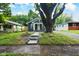 Inviting home exterior with a lush green lawn and mature trees at 3562 E Morris St, Indianapolis, IN 46203