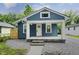Charming blue house with a welcoming front porch and well-maintained landscaping at 3562 E Morris St, Indianapolis, IN 46203