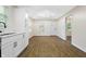 Well-lit open kitchen with white cabinetry, black hardware, and hardwood flooring at 3562 E Morris St, Indianapolis, IN 46203