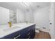 Bathroom with double sinks, blue vanity and marble counters, a shower, and a separate water closet at 3931 Tekesbury Ct, Plainfield, IN 46168
