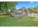 A view of the home's exterior with a large backyard, patio, and lush greenery at 3931 Tekesbury Ct, Plainfield, IN 46168