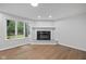 Cozy living room featuring a decorative fireplace and a bright window overlooking the landscape at 3931 Tekesbury Ct, Plainfield, IN 46168