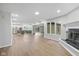 Spacious living room with fireplace and large windows, flowing into the kitchen with an open concept at 3931 Tekesbury Ct, Plainfield, IN 46168
