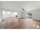 Spacious living room featuring a fan, a sliding glass door and access to other areas of the home at 3931 Tekesbury Ct, Plainfield, IN 46168