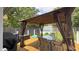 Backyard deck under a gazebo has a table and chairs and offers an outdoor seating area at 408 Ottawa Dr, Indianapolis, IN 46217